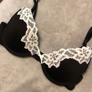 Black bra with white lace detail. 34B